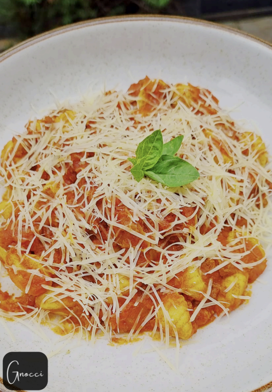 Homemade gnocchi with tomato sauce and parmesan