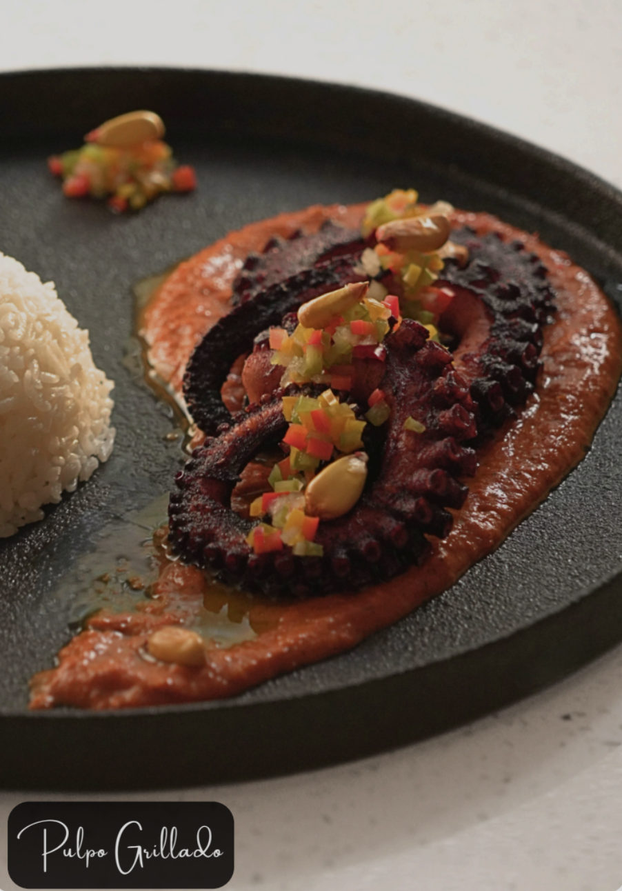 Grilled octopus with red sauce and garnishes